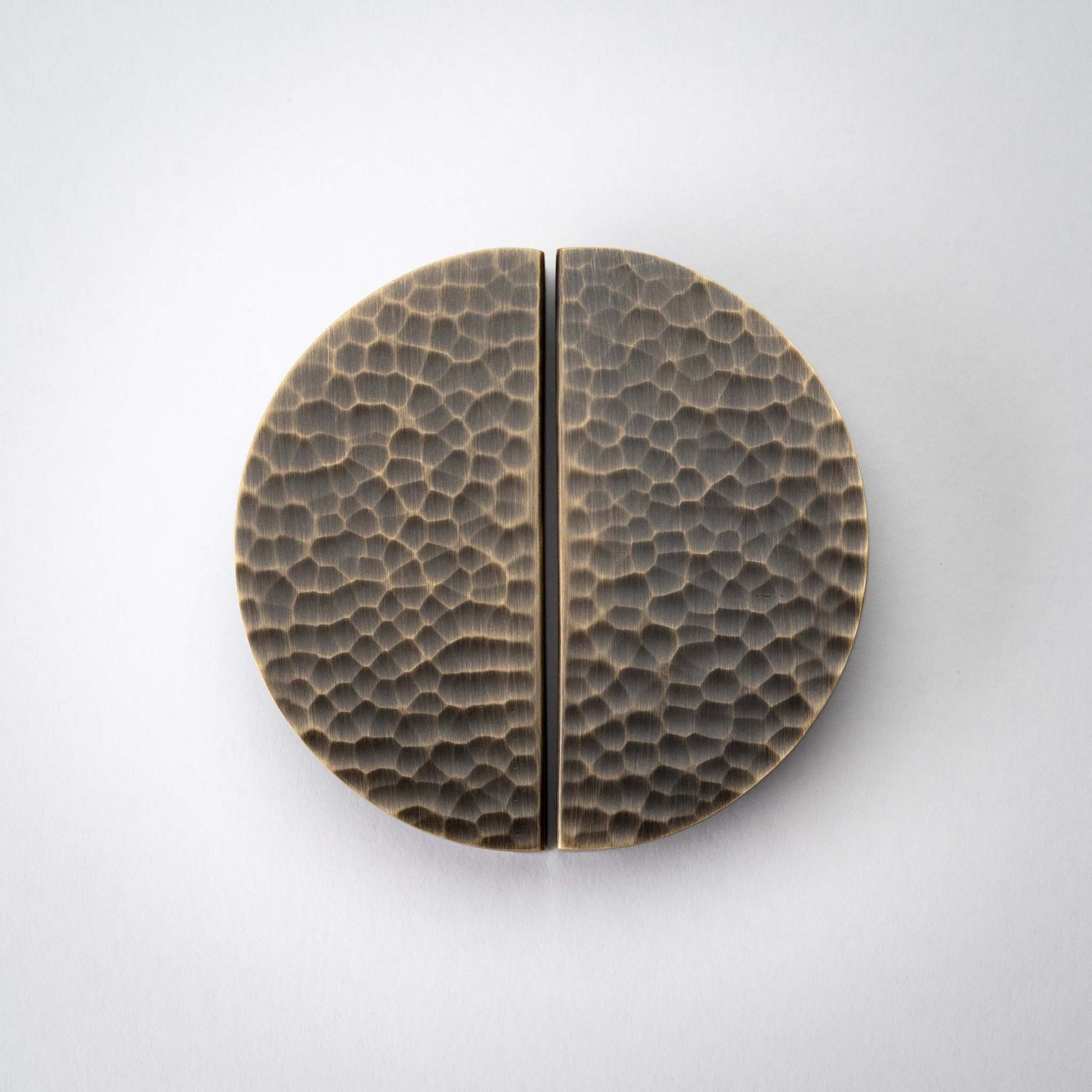 Hammered Demi Lune, Solid Brass Half Moon Cabinet PullsThis Demi Lune Hammered Pull is crafted from solid brass and finished with a unique hammered texture. With its half-moon shape, it's a charming addition to any kitchpullHammered Demi Lune, Solid Brass Half Moon Pulls