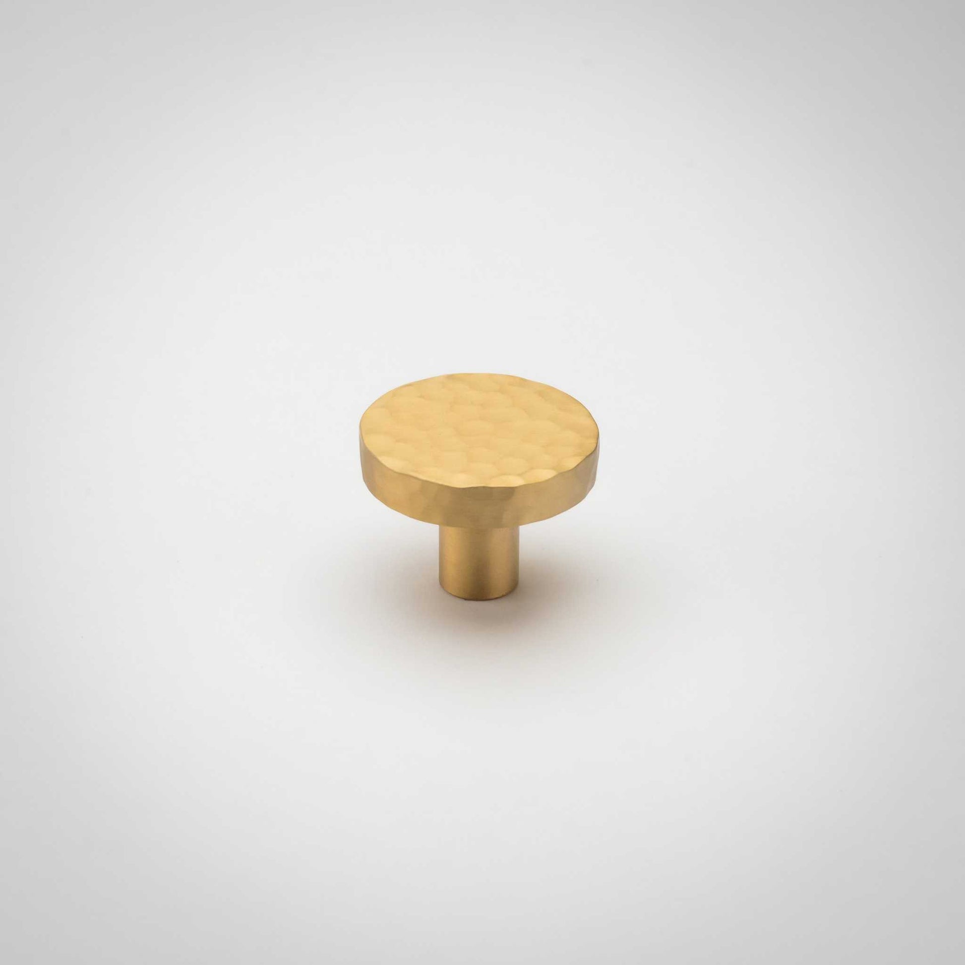 Strike, Hammered Solid Brass Cabinet KnobsOur Strike knob is hand-hammered for a stylish twist on the traditional cabinet knob. Provides a subtle sparkle to your transitional cabinet doors and drawers.KnobStrike, Solid Brass Hammered Cabinet Knobs