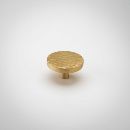 Strike, Hammered Solid Brass Cabinet KnobsOur Strike knob is hand-hammered for a stylish twist on the traditional cabinet knob. Provides a subtle sparkle to your transitional cabinet doors and drawers.KnobStrike, Solid Brass Hammered Cabinet Knobs