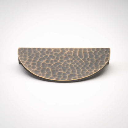 Hammered Demi Lune, Solid Brass Half Moon Cabinet PullsThis Demi Lune Hammered Pull is crafted from solid brass and finished with a unique hammered texture. With its half-moon shape, it's a charming addition to any kitchpullHammered Demi Lune, Solid Brass Half Moon Pulls