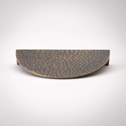 Hammered Demi Lune, Solid Brass Half Moon Cabinet PullsThis Demi Lune Hammered Pull is crafted from solid brass and finished with a unique hammered texture. With its half-moon shape, it's a charming addition to any kitchpullHammered Demi Lune, Solid Brass Half Moon Pulls